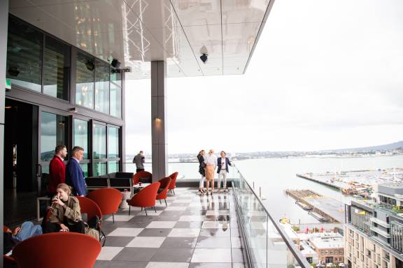 People standing and sitting at a rooftop