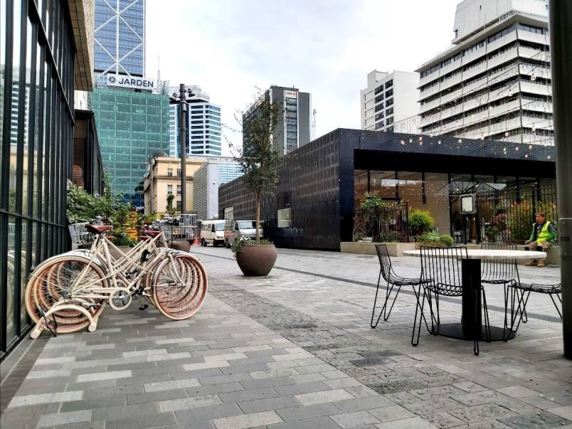 Galway Street in Britomart - an attractively paved shared space with bikes parked in front of a building and outdoor cafe seating.