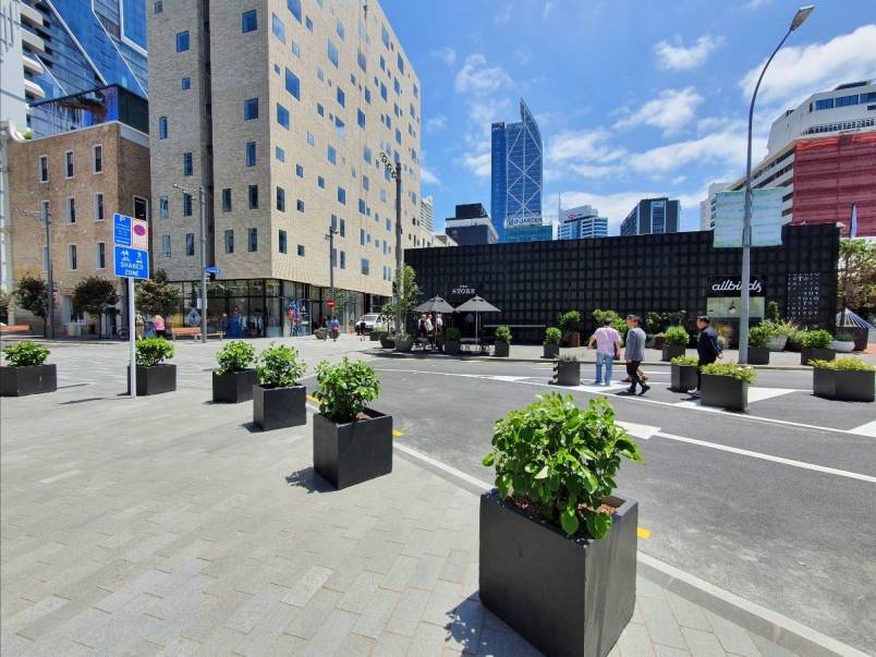 Planters in the foreground, the Hotel Britomart and blue sky in the background, with Britomart's newly upgraded Gore Street in the middle. 